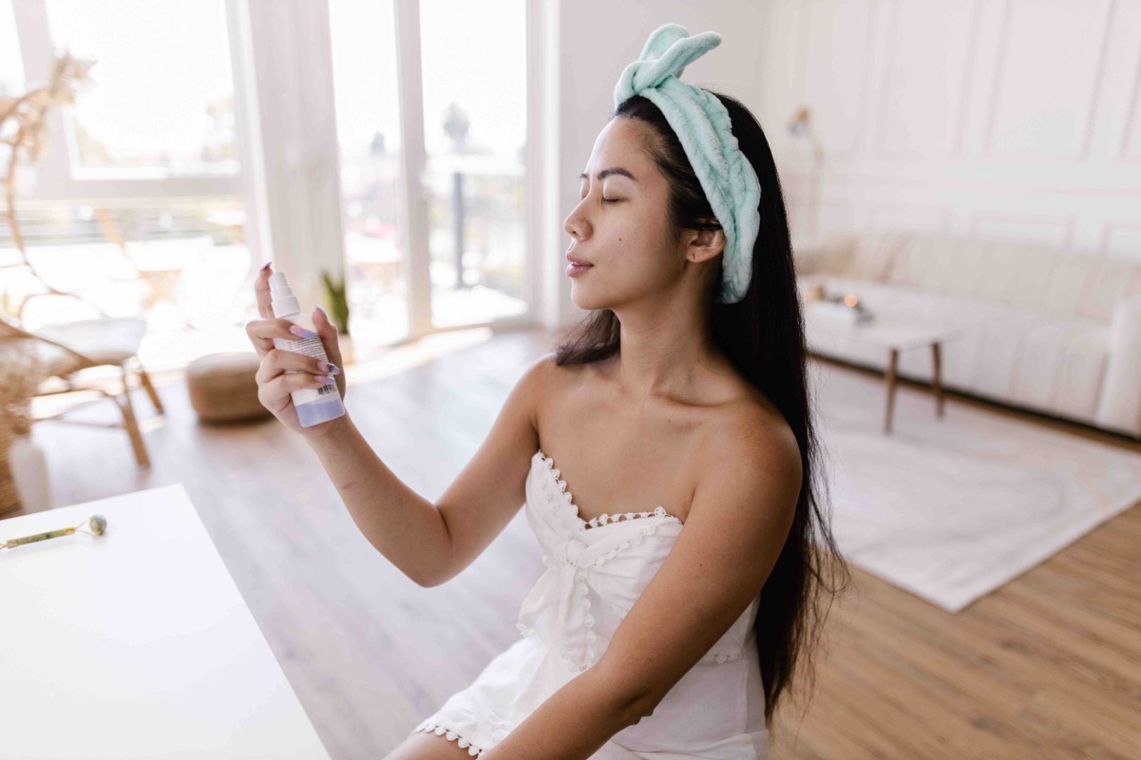woman applying skincare mist for her skincare routine