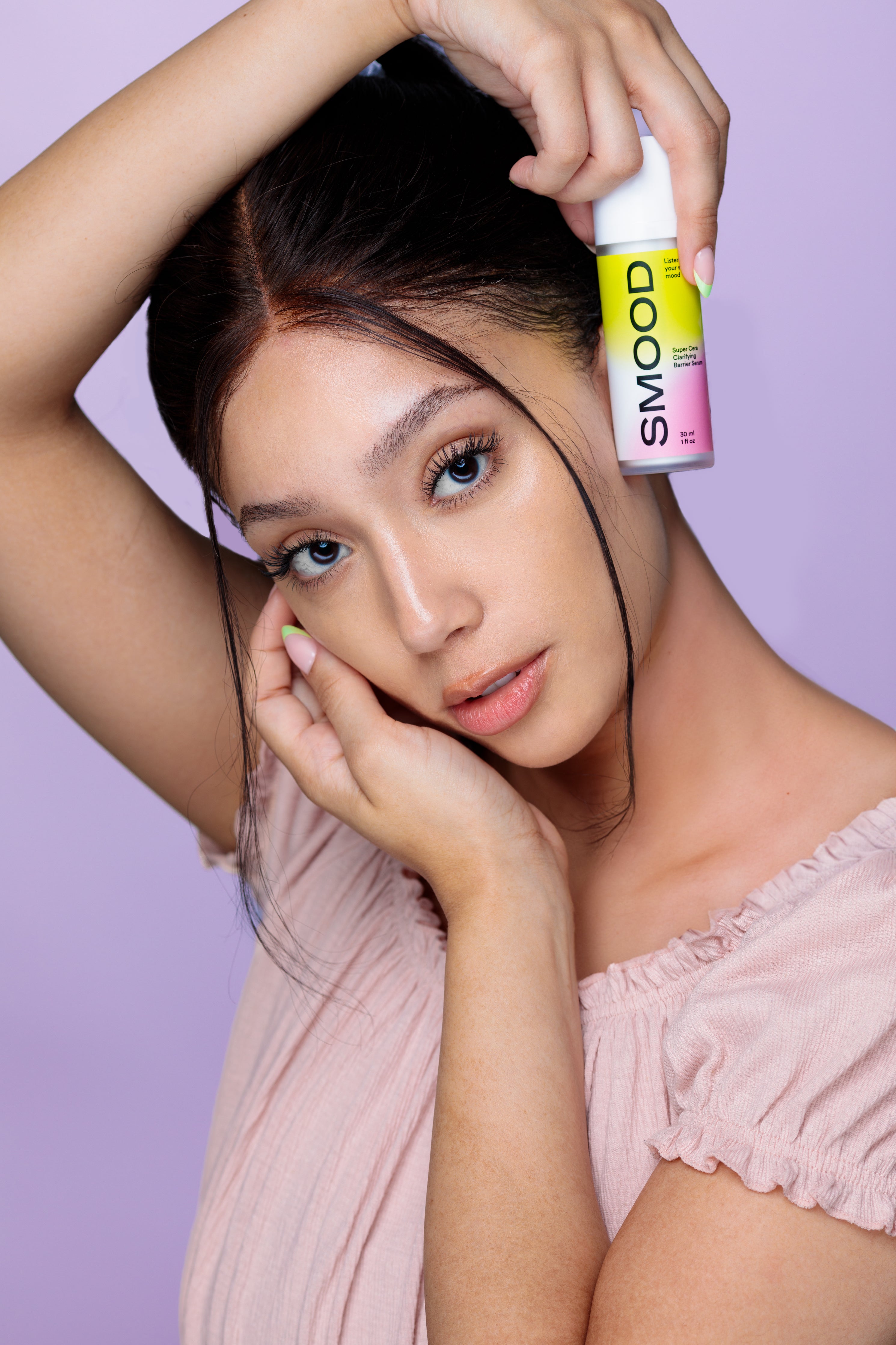 Super Cera Clarifying Barrier Serum from Smood Beauty with model holding serum in hand